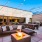 Outdoor lounge space with fire, comfortable seats, and dining space