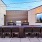 Outdoor lounge space with fire, comfortable seats, and dining space